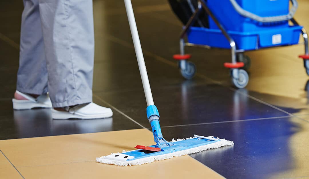 Janitor mopping a floor in a commercial building